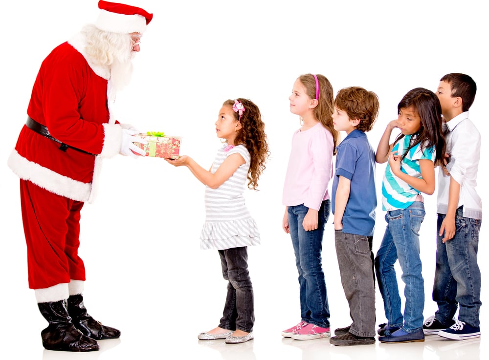 Santa giving Christmas presents to a group of kids lining up - isolated Santa giving Christmas presents to a group of kids lining up - isolated